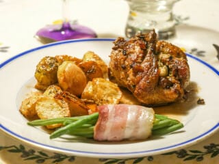 Quail stuffed with napa cabbage, served with a port sauce and garlic and rosemary baby potatoes