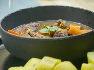 Sautéed veal with carrots, served with a spiced wine sauce